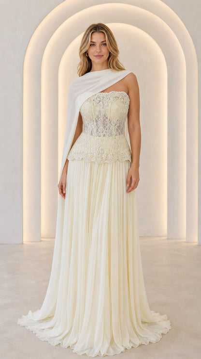Ivory strapless lace corset maxi gown with pleated skirt and sheer shoulder drape - front view
