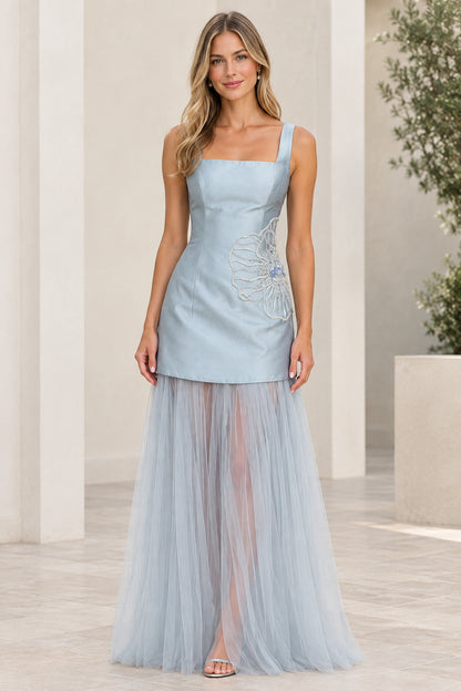 Front view of model wearing light blue square neck evening gown with sheer tulle skirt
