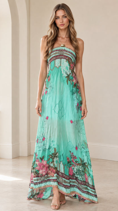 Front view of woman wearing turquoise strapless floral maxi dress with embellished neckline
