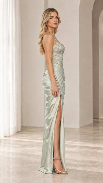 Side profile of model wearing sage green draped satin evening dress