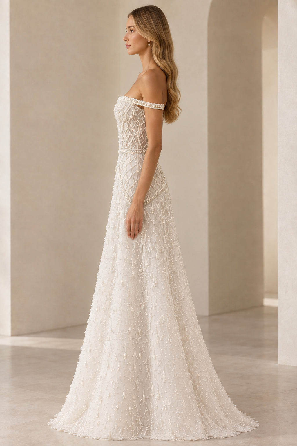 Side profile view of ivory pearl beaded A-line evening gown