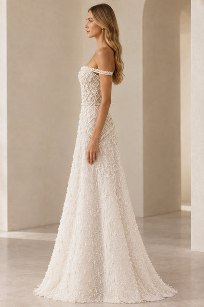 Side profile view of ivory pearl beaded A-line evening gown