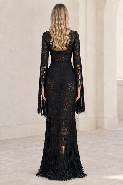 Back view of model wearing black lace evening dress with fringe details