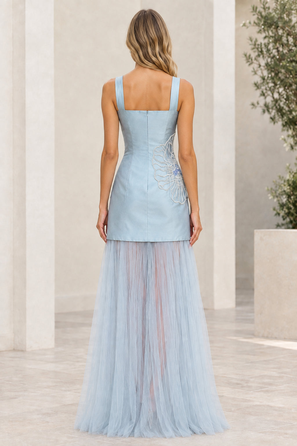 Back view of model in light blue sleeveless square neck gown