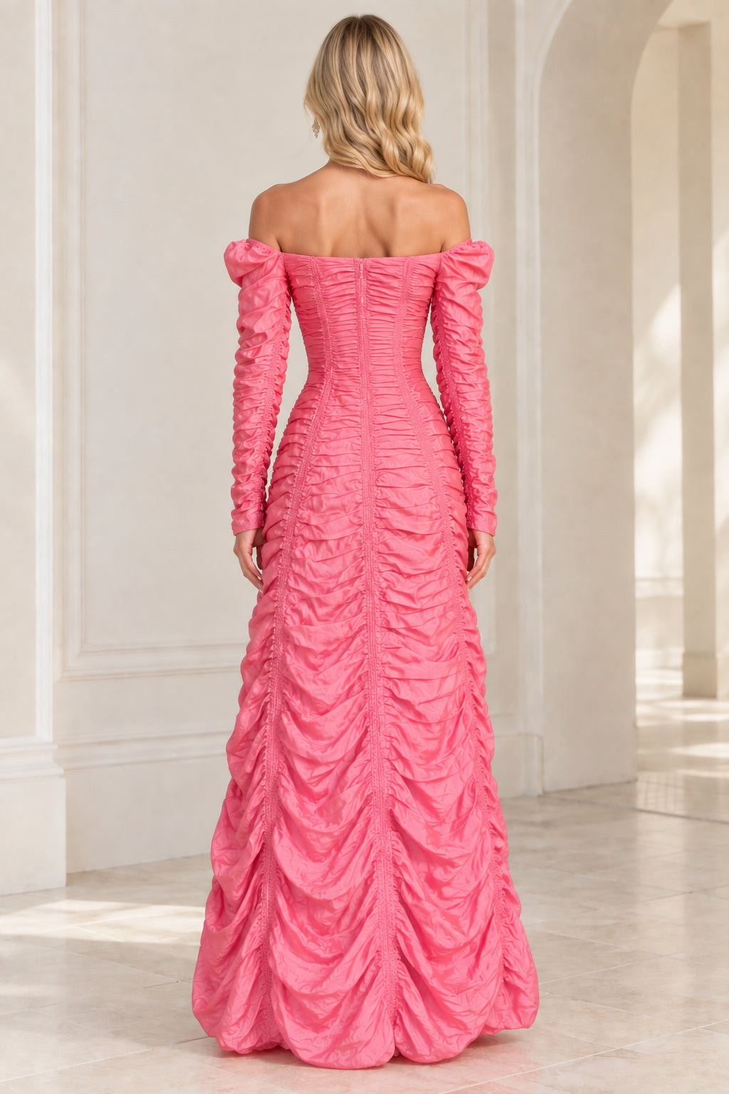 Back view of woman wearing pink ruched off-the-shoulder maxi dress