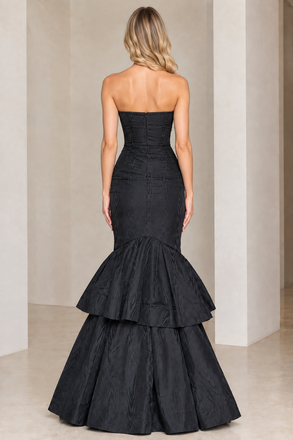 Back view of black strapless evening gown showing zipper closure