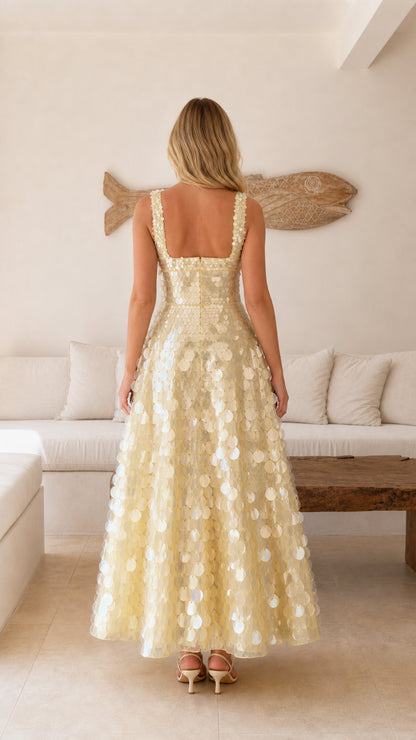 Back view of model wearing a champagne sequin sleeveless maxi dress with square back