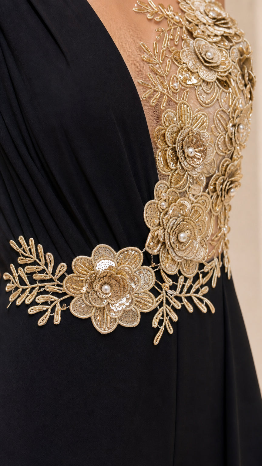 Close-up detail of sheer illusion mesh and metallic gold sequin flower embroidery on jumpsuit bodice