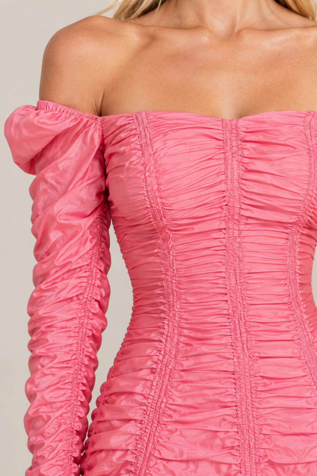 Close-up detail of gathered ruching and off-the-shoulder bodice on pink gown