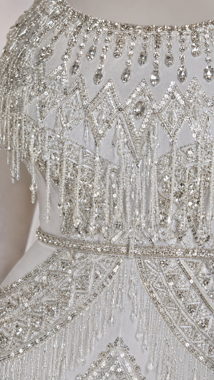 Detailed close-up of intricate crystal beadwork, sequins, and shoulder fringe