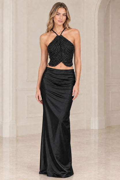Black two-piece evening gown set with beaded halter top and satin column skirt