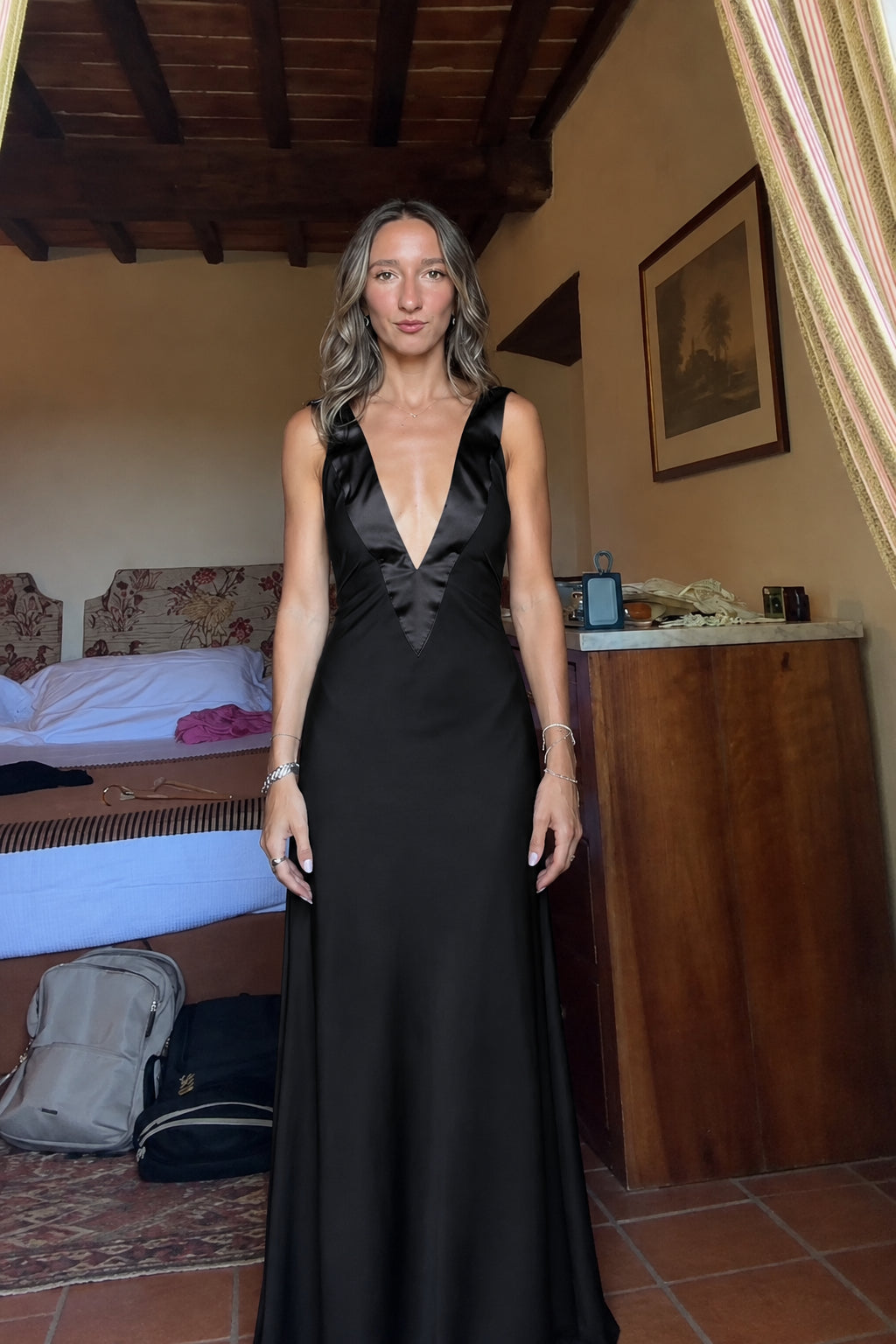 Front view of black deep V-neck satin maxi dress
