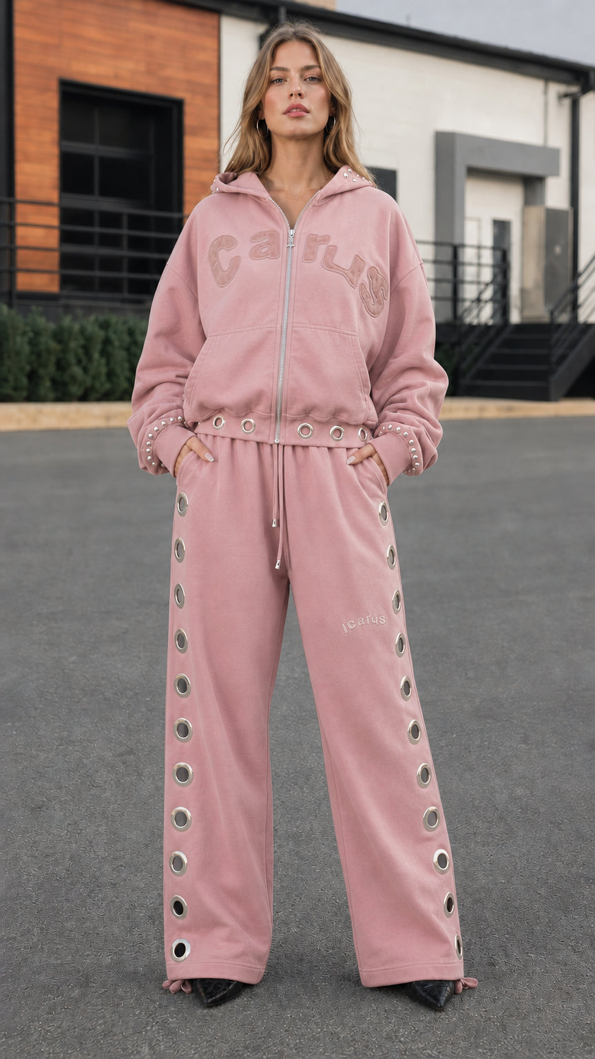 Full front view of model wearing dusty pink grommet wide-leg tracksuit set