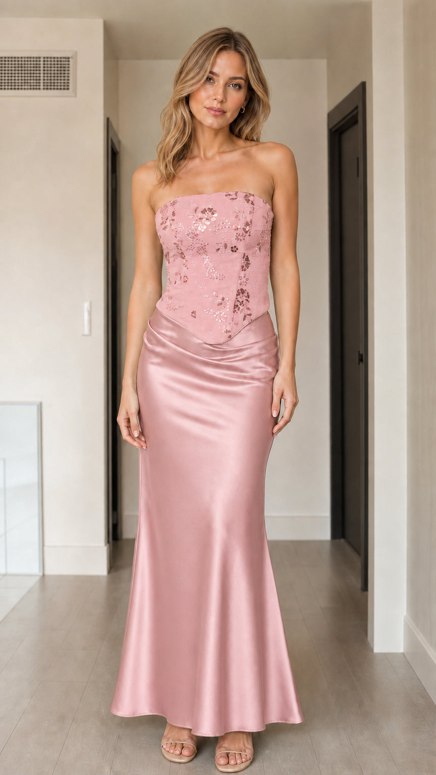 Front view of woman wearing dusty pink strapless sequin corset satin maxi dress
