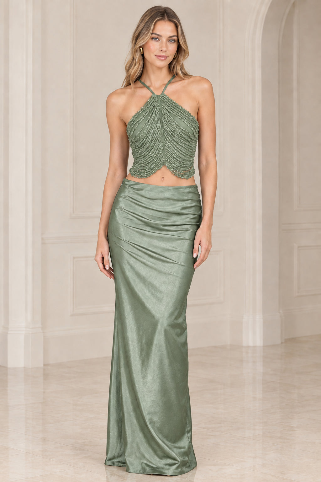 Sage green two-piece evening gown with embellished halter top and long satin skirt