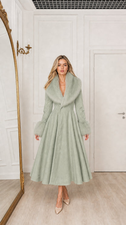 Model wearing sage green swing midi coat with matching faux fur collar and cuffs