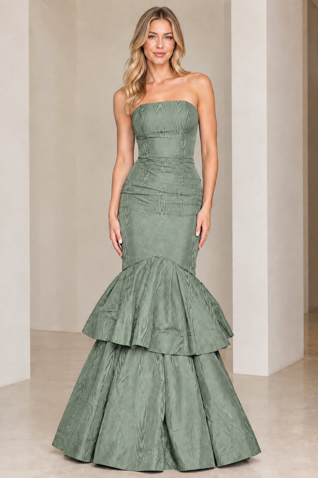 Model wearing sage green strapless tiered mermaid evening gown