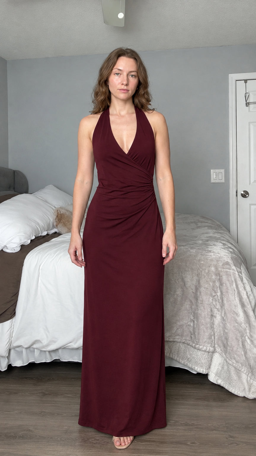 Front view of woman wearing burgundy wine red halter neck evening maxi dress
