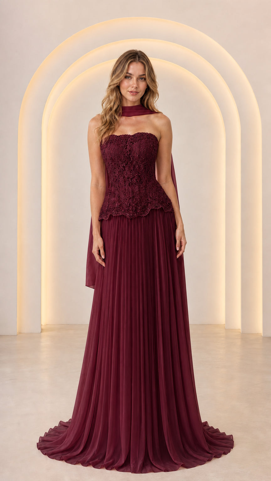 Front view of Burgundy wine red strapless formal dress with lace peplum and pleated skirt