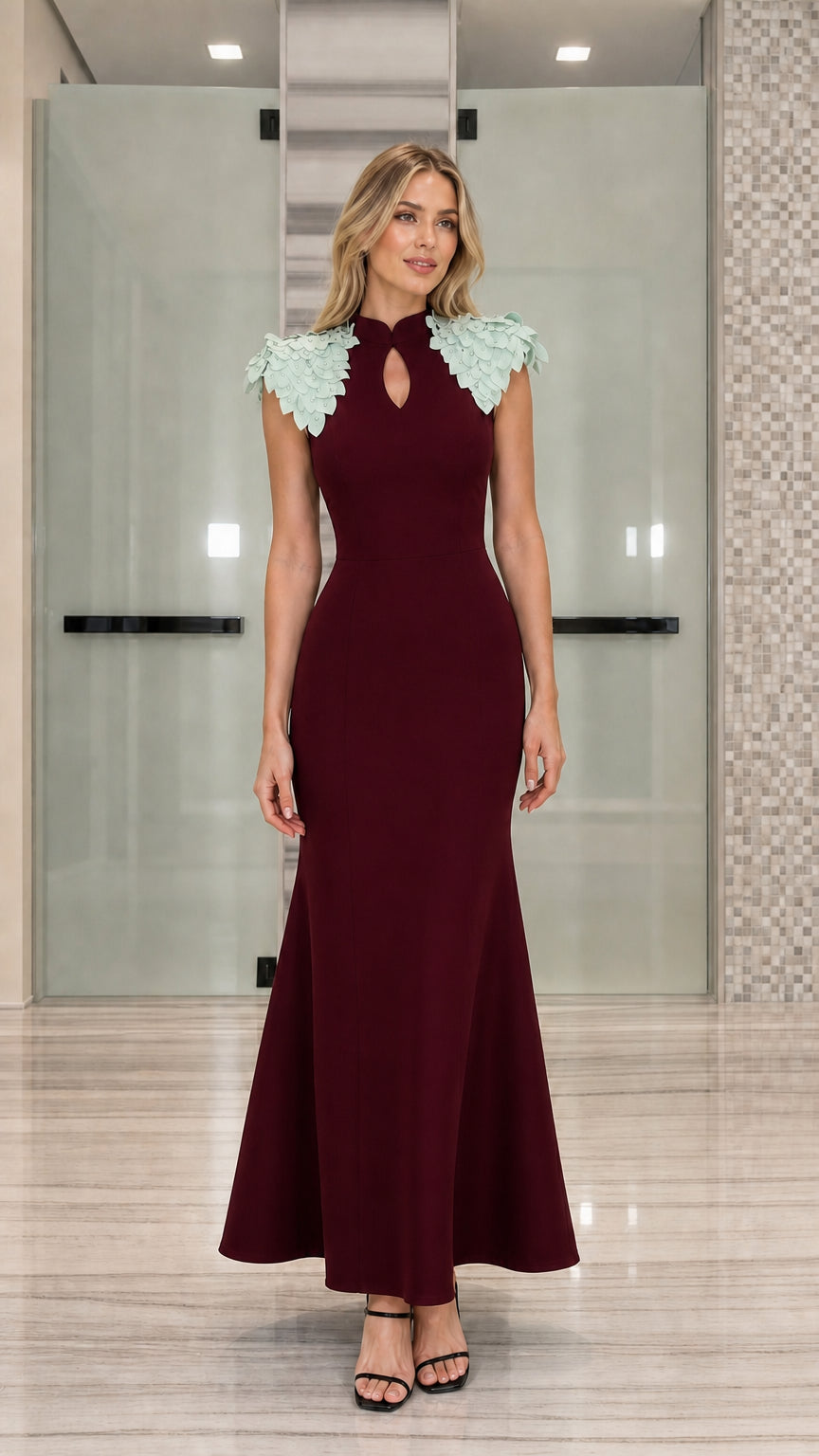 Full-length view of burgundy red mermaid evening gown with contrast mint petal shoulders