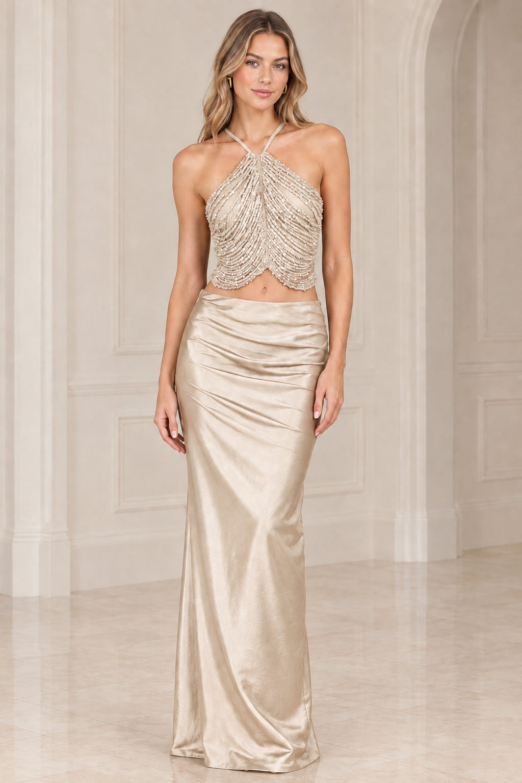 Champagne gold two-piece evening gown with beaded halter top and satin skirt