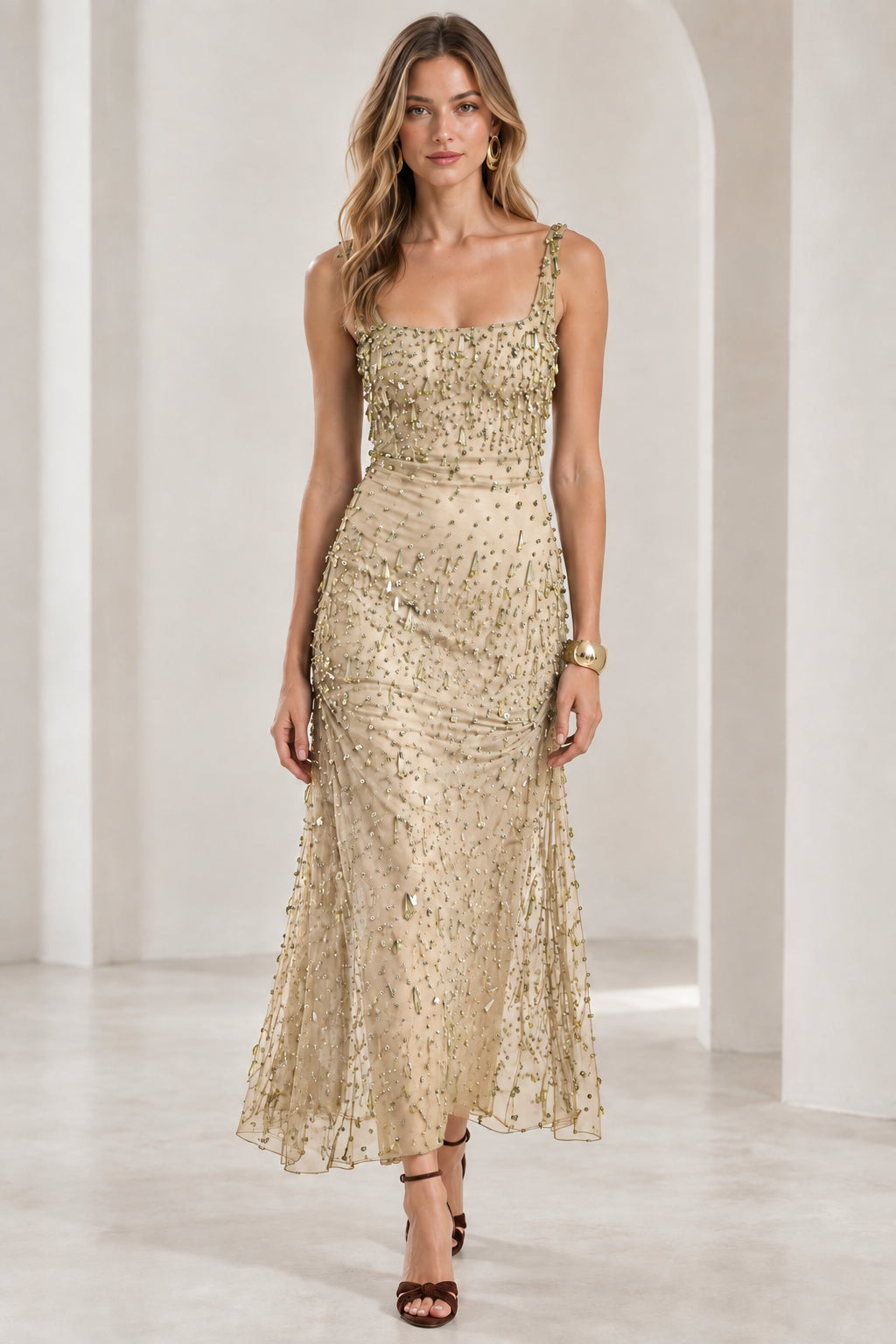 Front view of model wearing champagne gold beaded square neck gown